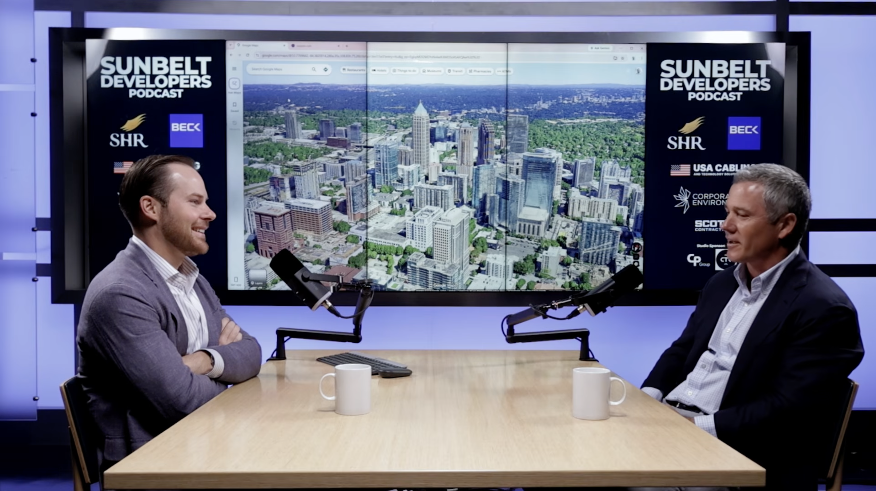 A Sunbelt Developers conversation at the studio table, with Atlanta’s skyline on the screen behind the guests